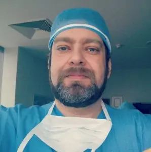 جراح تجميل يرتدي الزي الطبي في عيادة Gürler Akınbingöl M.D. Aesthetic & Plastic Surgery