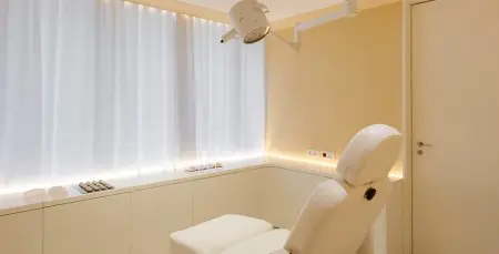 Sala de tratamiento moderna con sillón de examen en UPClinic