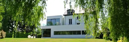 Exterior de la Clínica BeauCare con arquitectura moderna y jardín en Bélgica