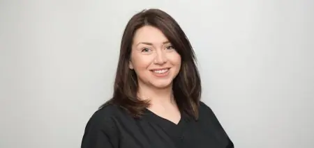 عضو فريق طبي بزي رسمي في عيادة Hawkins Dental & Implant Clinic