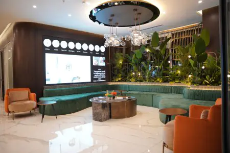 Modern waiting area at Dentakay Dental Clinic Istanbul with green seating and plants