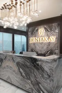 Reception area at Dentakay Dental Clinic with modern marble desk and stylish lighting