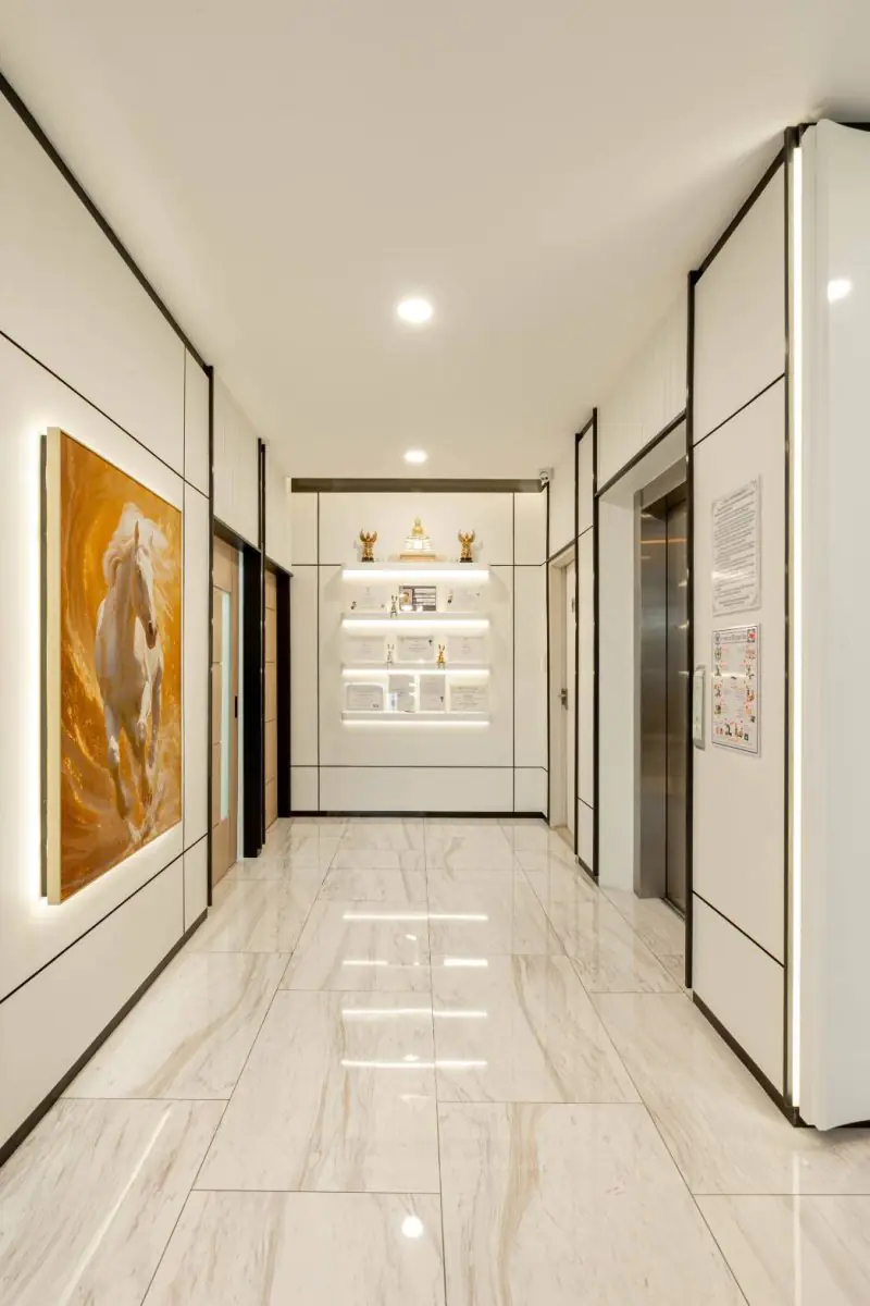 Modern hallway at Dr.Nutt Clinic with elevators and illuminated decor in Bangkok
