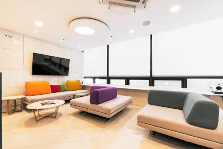 Waiting room at Returning Plastic Surgery clinic with modern colorful seating