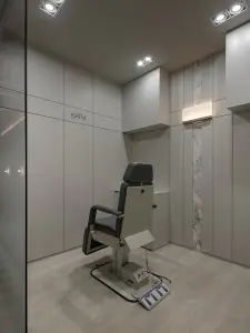 Modern medical examination room with adjustable chair at Forena Clinic