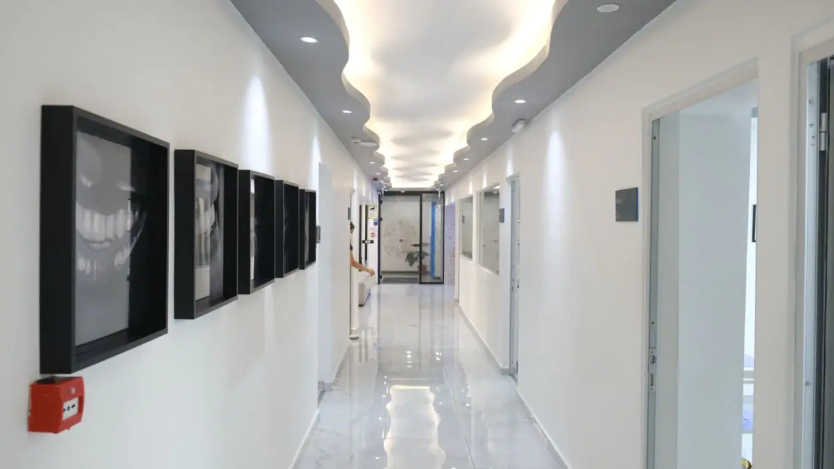 Modern hallway at Dentfix Turkey Clinic with dental art and bright lighting