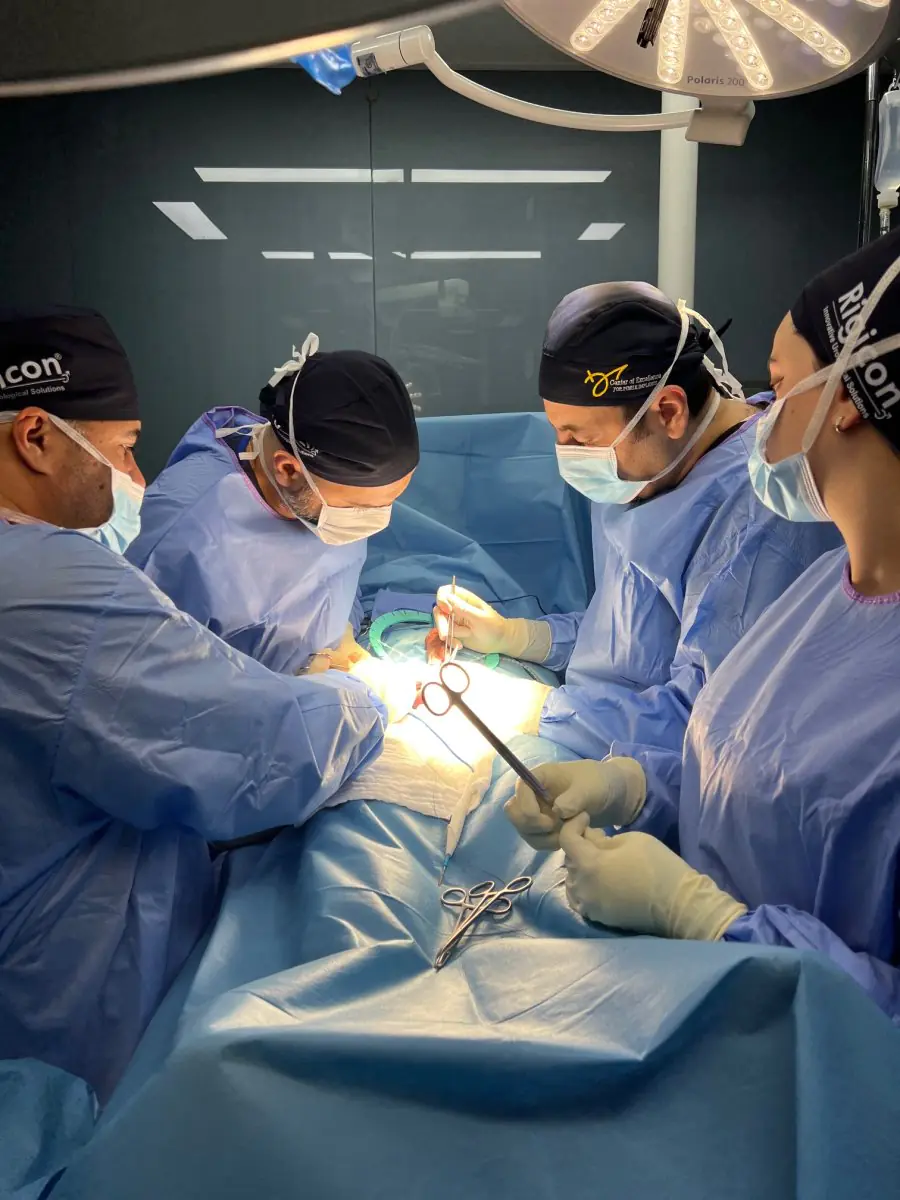 Surgical team performing operation in Uroaesthetic clinic operating room