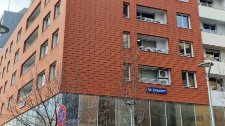 الواجهة الخارجية لعيادة Unident بواجهة حديثة حمراء ونوافذ كبيرة