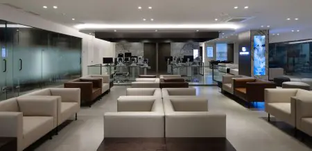 منطقة انتظار حديثة في عيادة Gangnam Brand Eye مع مقاعد مريحة وأجهزة فحص العيون
