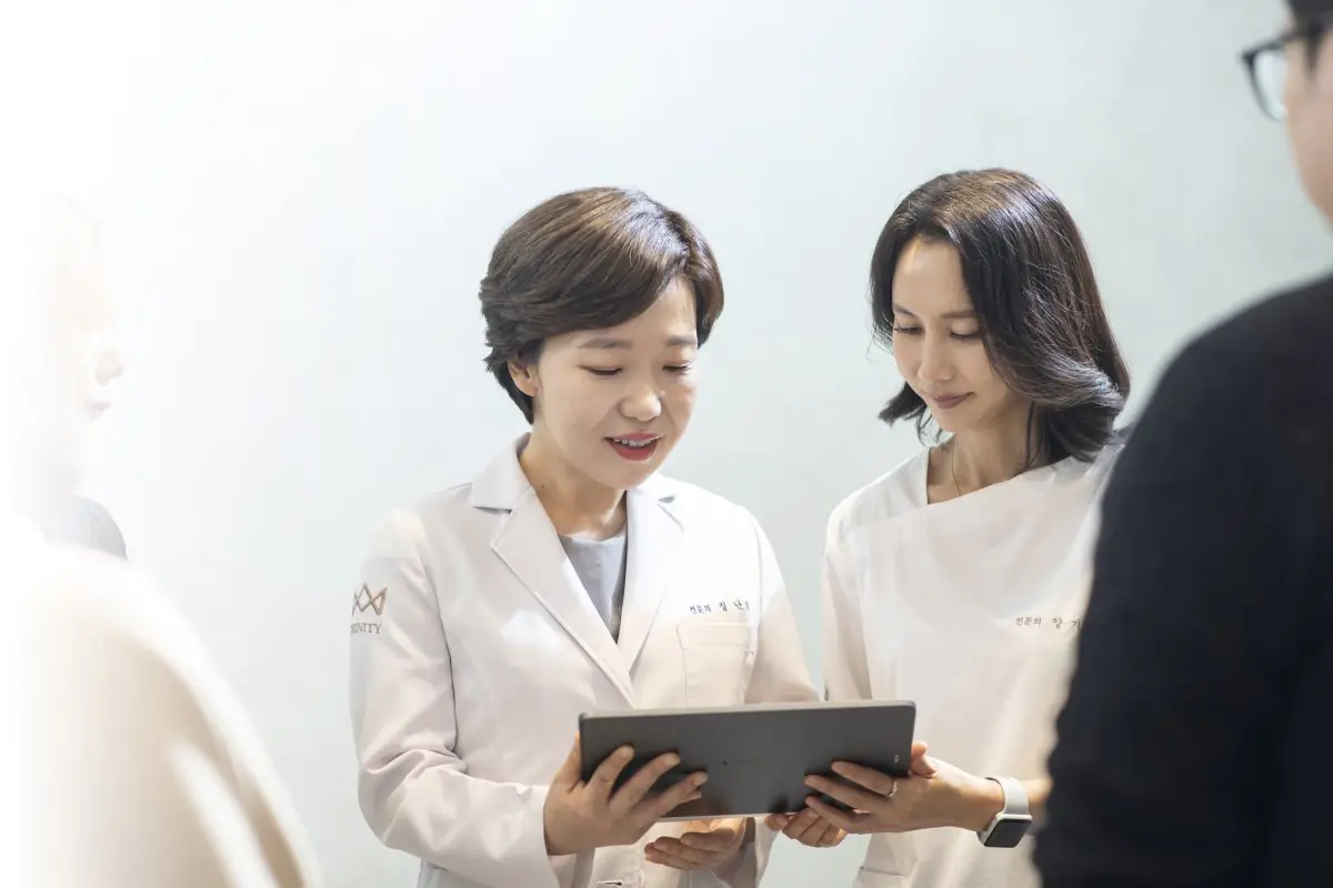 Medical staff consultation at Trinity Women's Clinic, doctors reviewing patient data