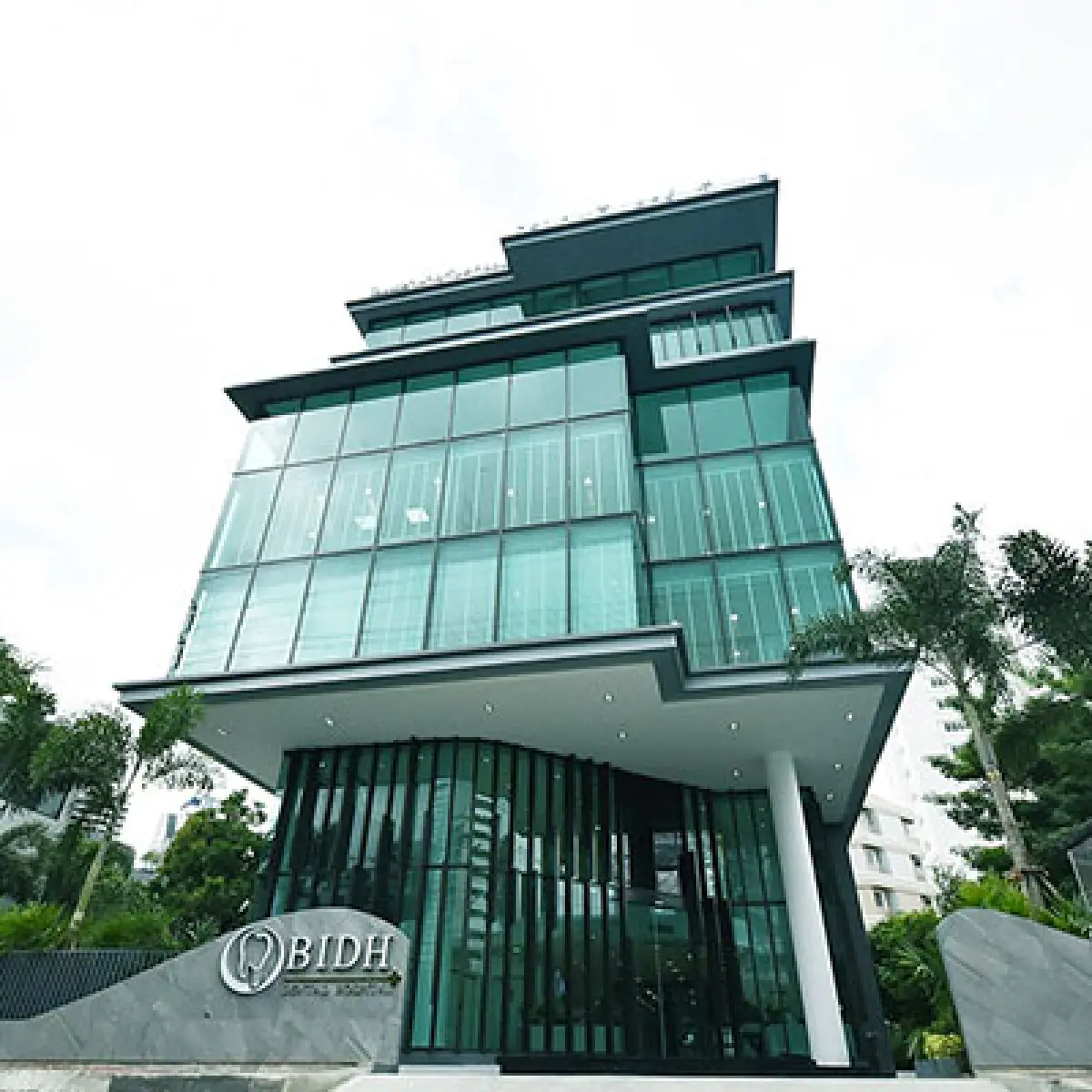 Modern glass facade of Bangkok Dental International Hospital in Thailand