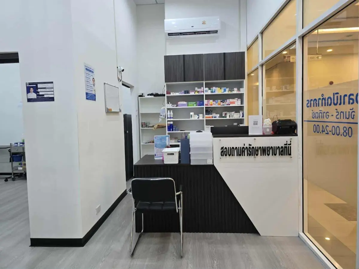 Mostrador de recepción en la clínica Doctor Bangkok con estantes de farmacia e interior moderno
