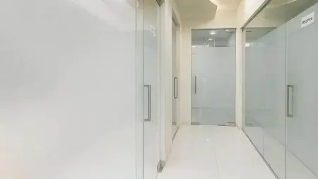 ممر عيادة حديث بأبواب زجاجية في Trisa Dental Solutions LLP