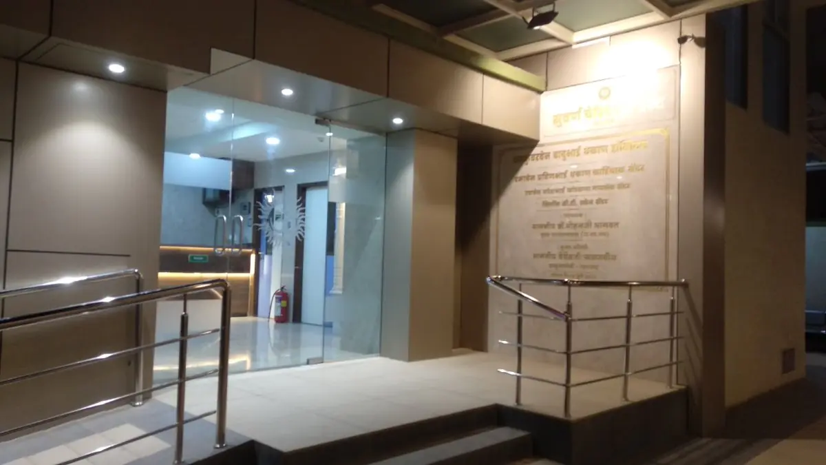Main entrance of Suvarna Hospital with glass doors and wheelchair ramp
