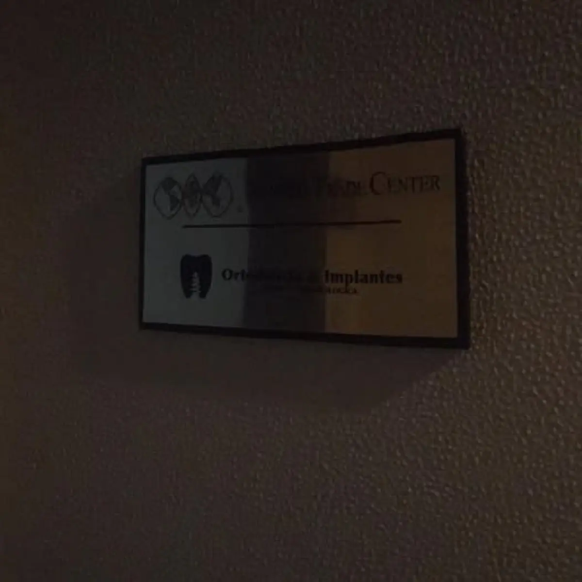 Ortodoncia & Implantes clinic wall sign with dental logo
