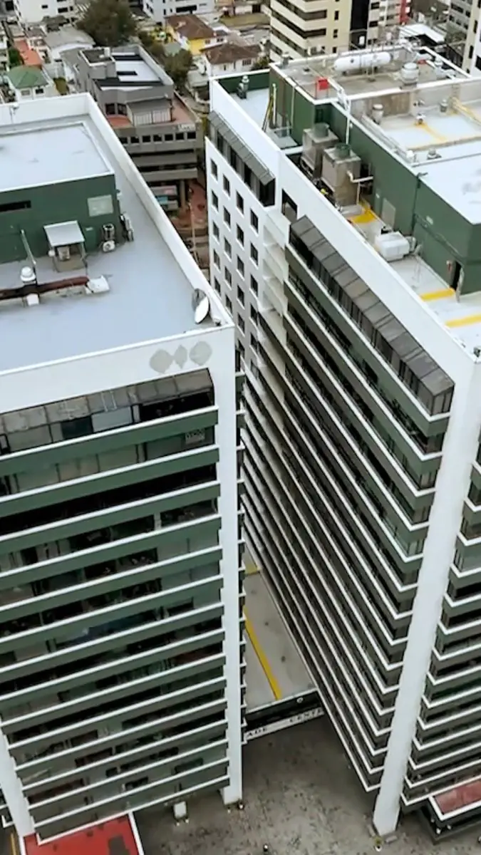 Ortodoncia & Implantes clinic exterior, modern high-rise building in city center