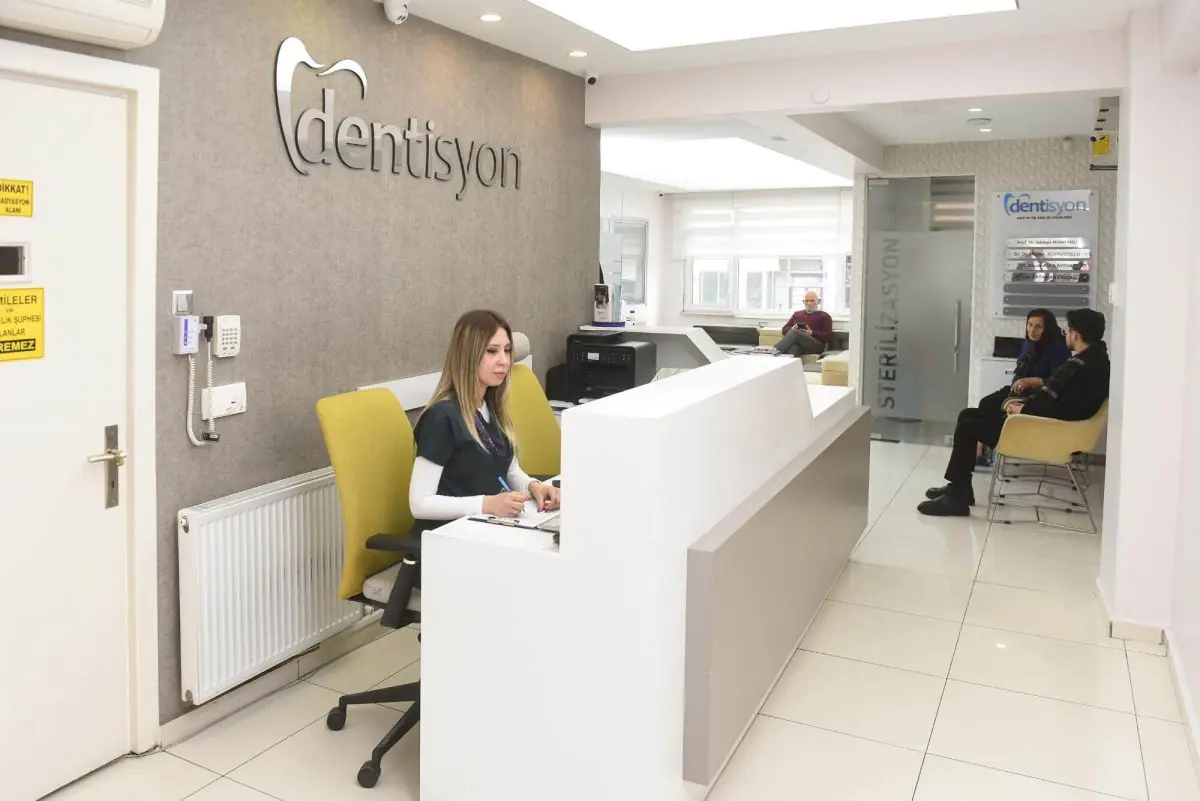 Reception area at Dentisyon Dental Clinic with modern seating and staff desk