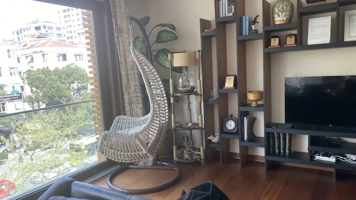 Modern waiting area at ORHAN ALAN CLINIC with lounge chair and city view