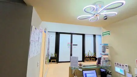 منطقة الاستقبال في عيادة GNUX Dental بإضاءة حديثة ومنطقة انتظار