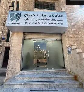 مدخل عيادة د. ماجد صباح لطب الأسنان بأبواب زجاجية ودرج حجري