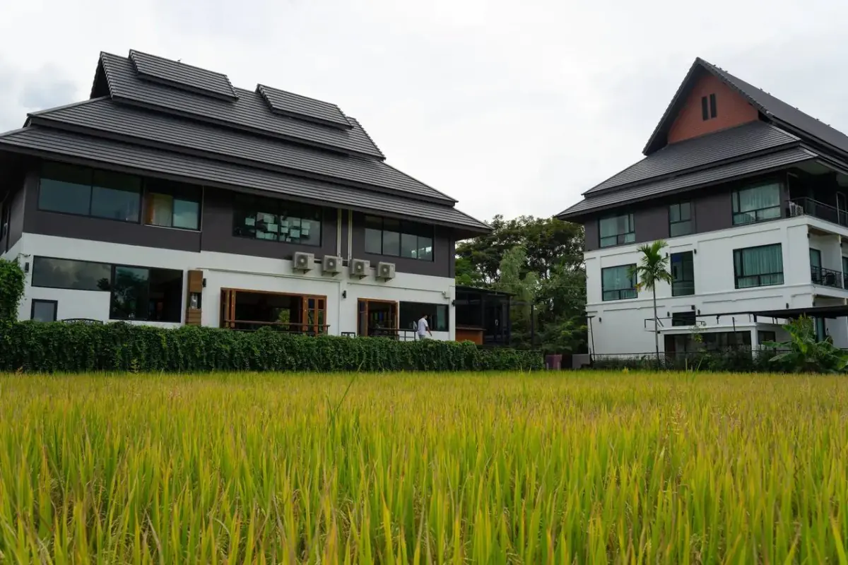 The Warmth Rehab clinic exterior with modern buildings and green landscape