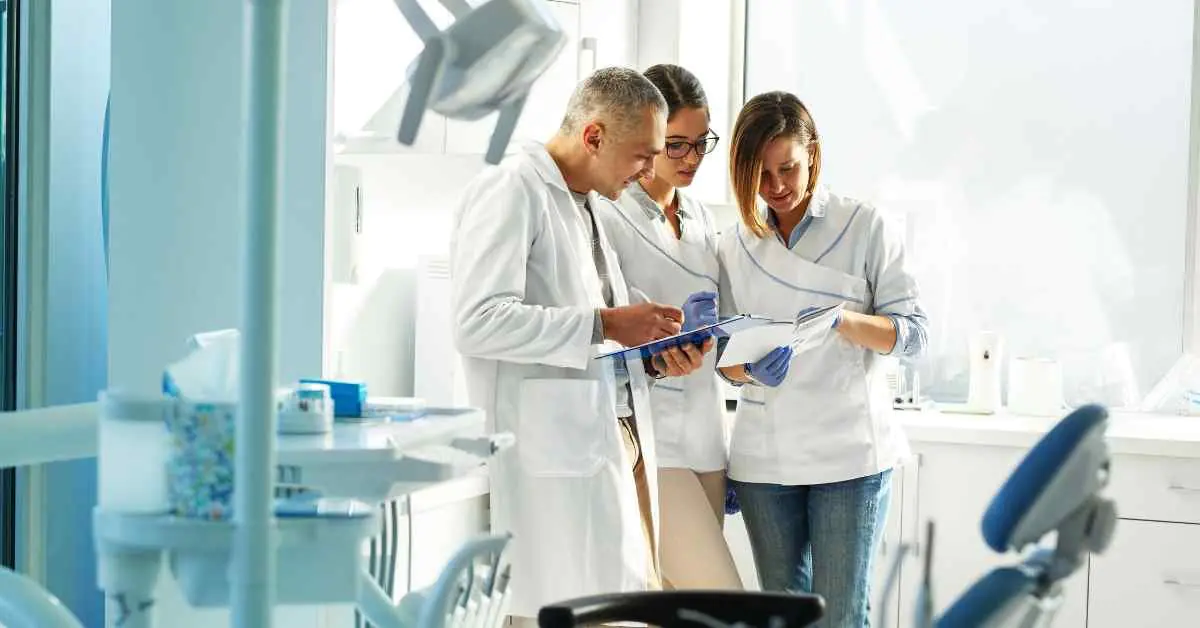 Dental team at Oral 360 clinic reviewing patient files in modern treatment room