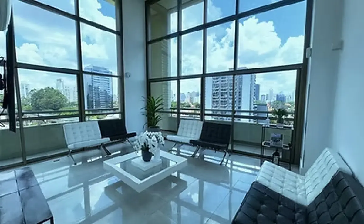 Waiting room at BCX Odontologia clinic with city view and modern seating