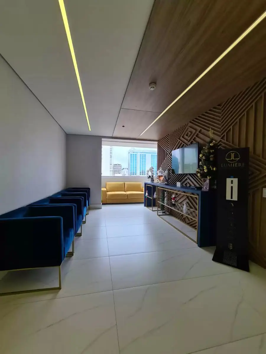 Modern waiting room at Lumière Odontologia clinic with stylish seating in Brazil
