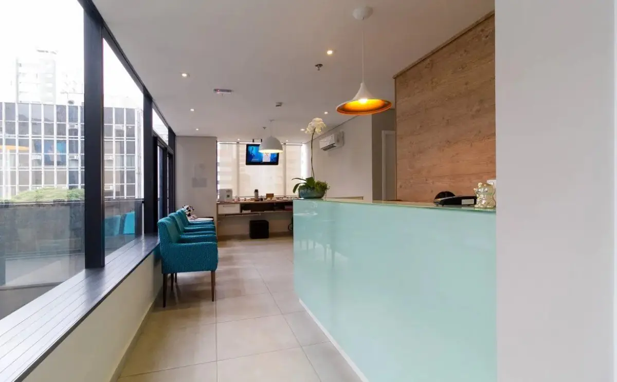 Reception area at Portal do Sorriso clinic with modern seating and large windows