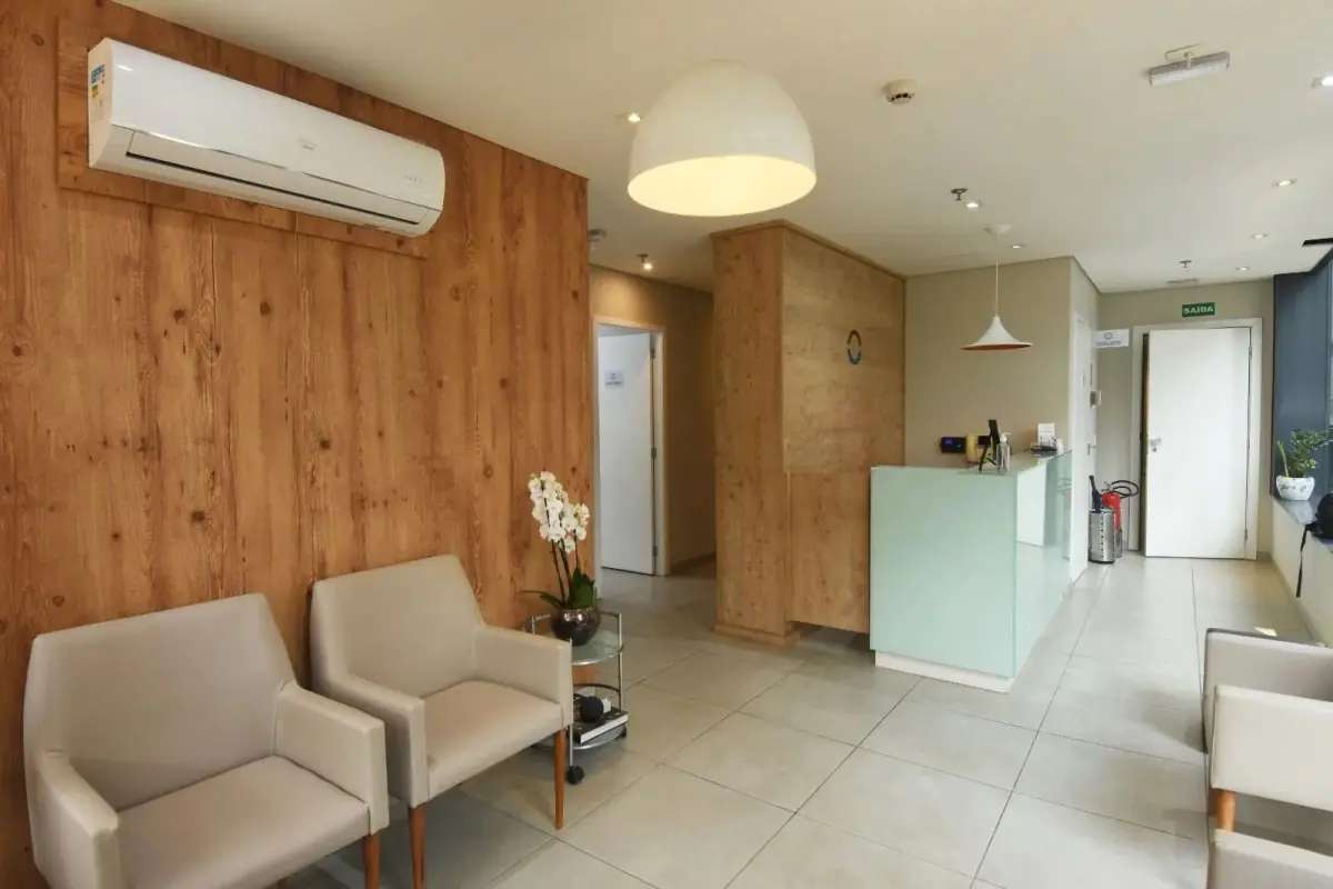 Reception area at Portal do Sorriso clinic with modern seating and wood accents