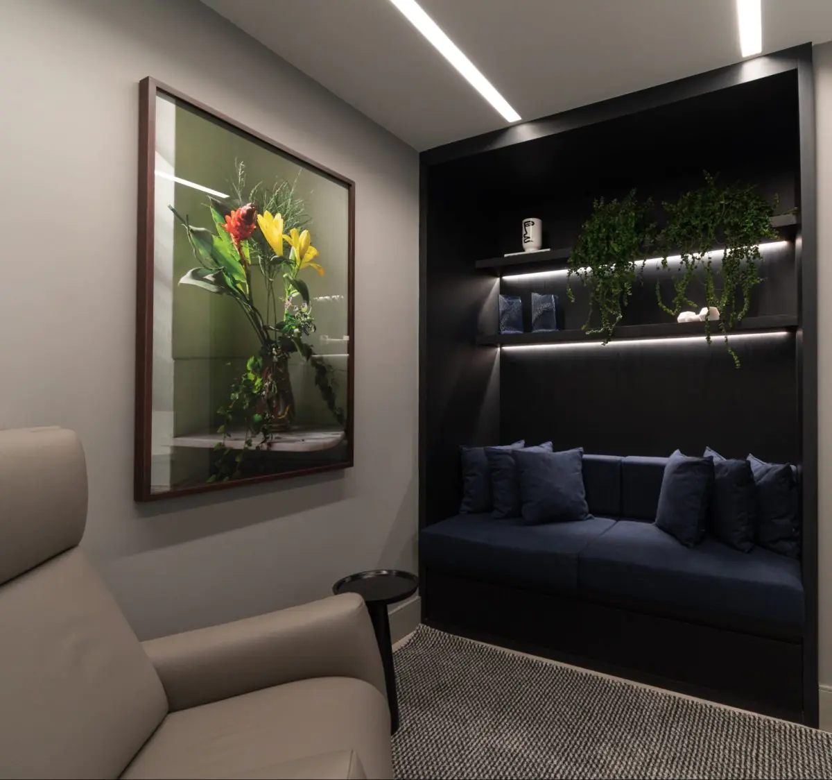 Sollos clinic waiting area with modern sofa, wall art, and indoor plants