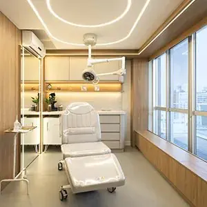 Sala de tratamiento moderna en Institute Beyond Plastic Surgery con sillón y vista a la ciudad