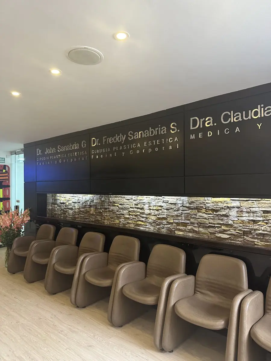 Plastic surgery clinic waiting area with modern chairs and stone accent wall