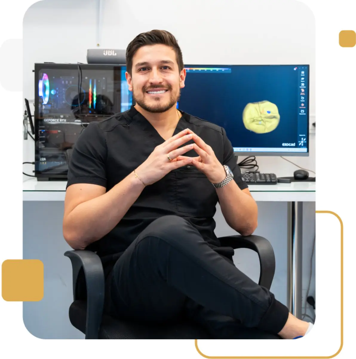 Dentist at Elite Smiles clinic with dental CAD software in modern office