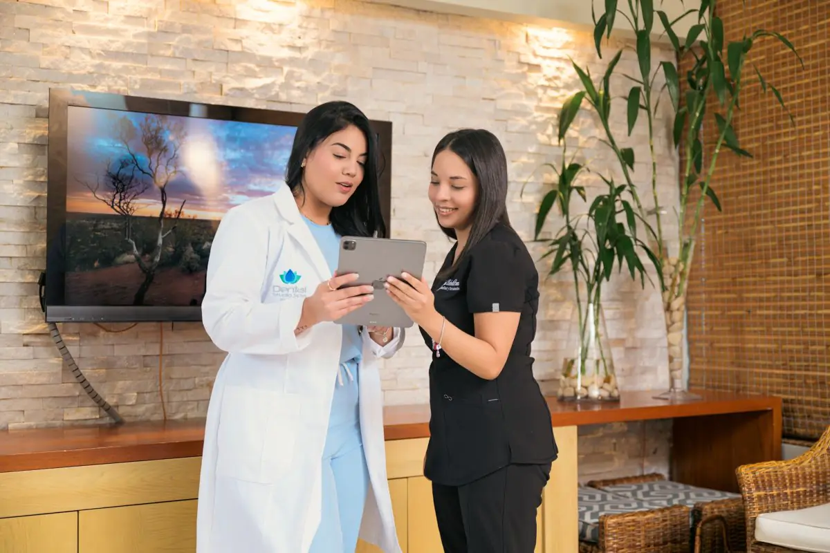 Dental Studio Spa staff discussing patient care in modern clinic interior