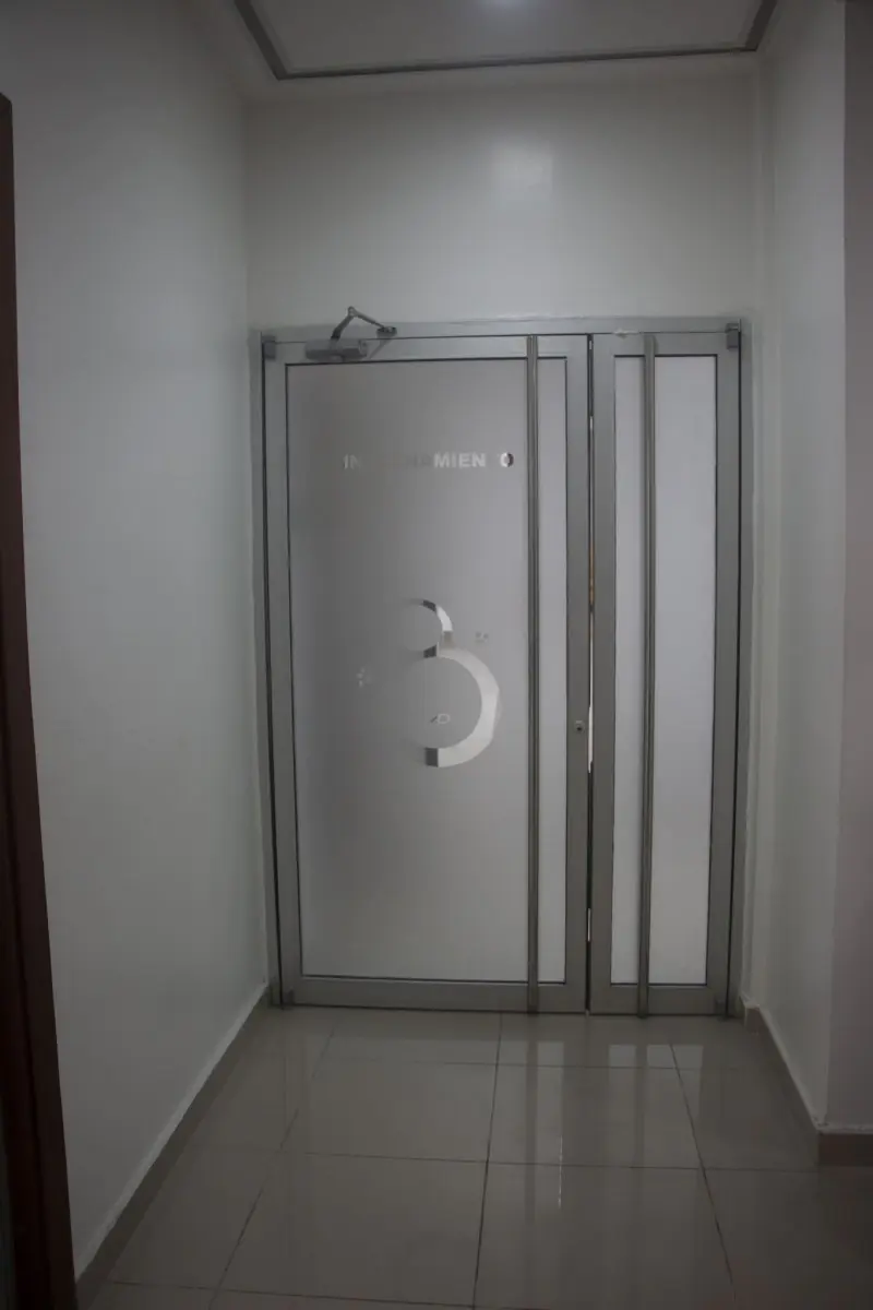 Clinic corridor with frosted glass door at DOCAMED medical facility