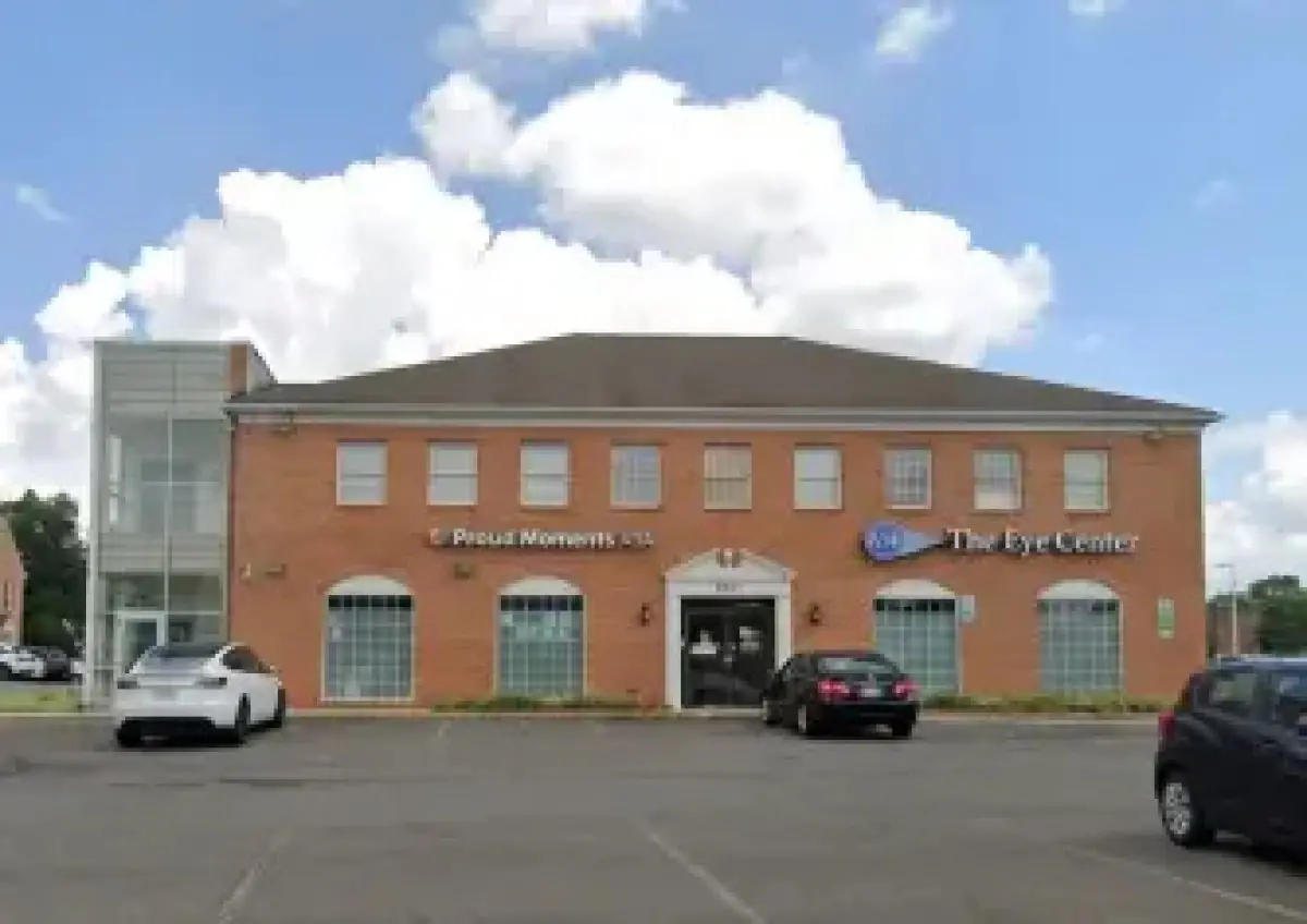 Clinic facade of The Eye Center with parking area in front