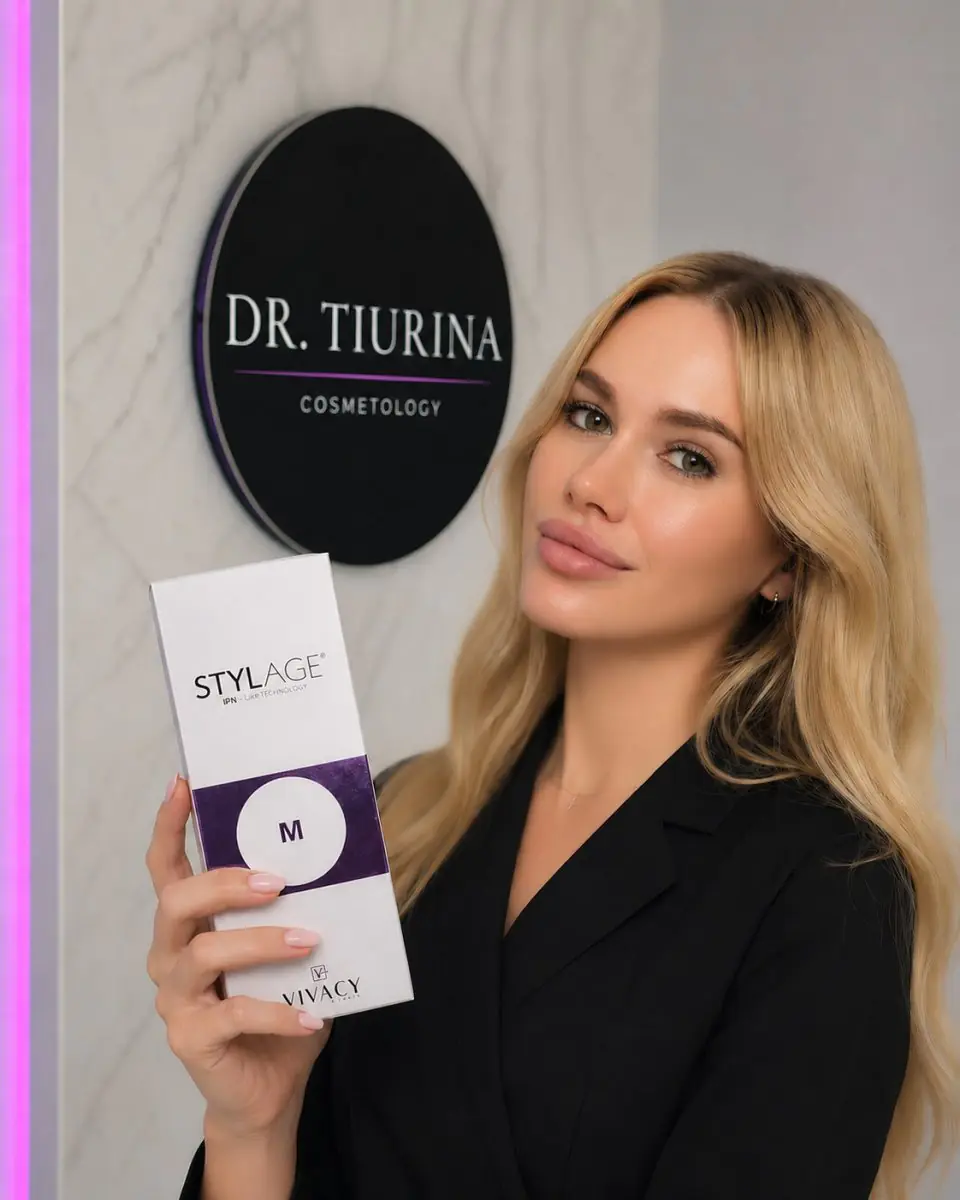 Cosmetologist at Dr. Tiurina Cosmetology Clinic holding Stylage filler box