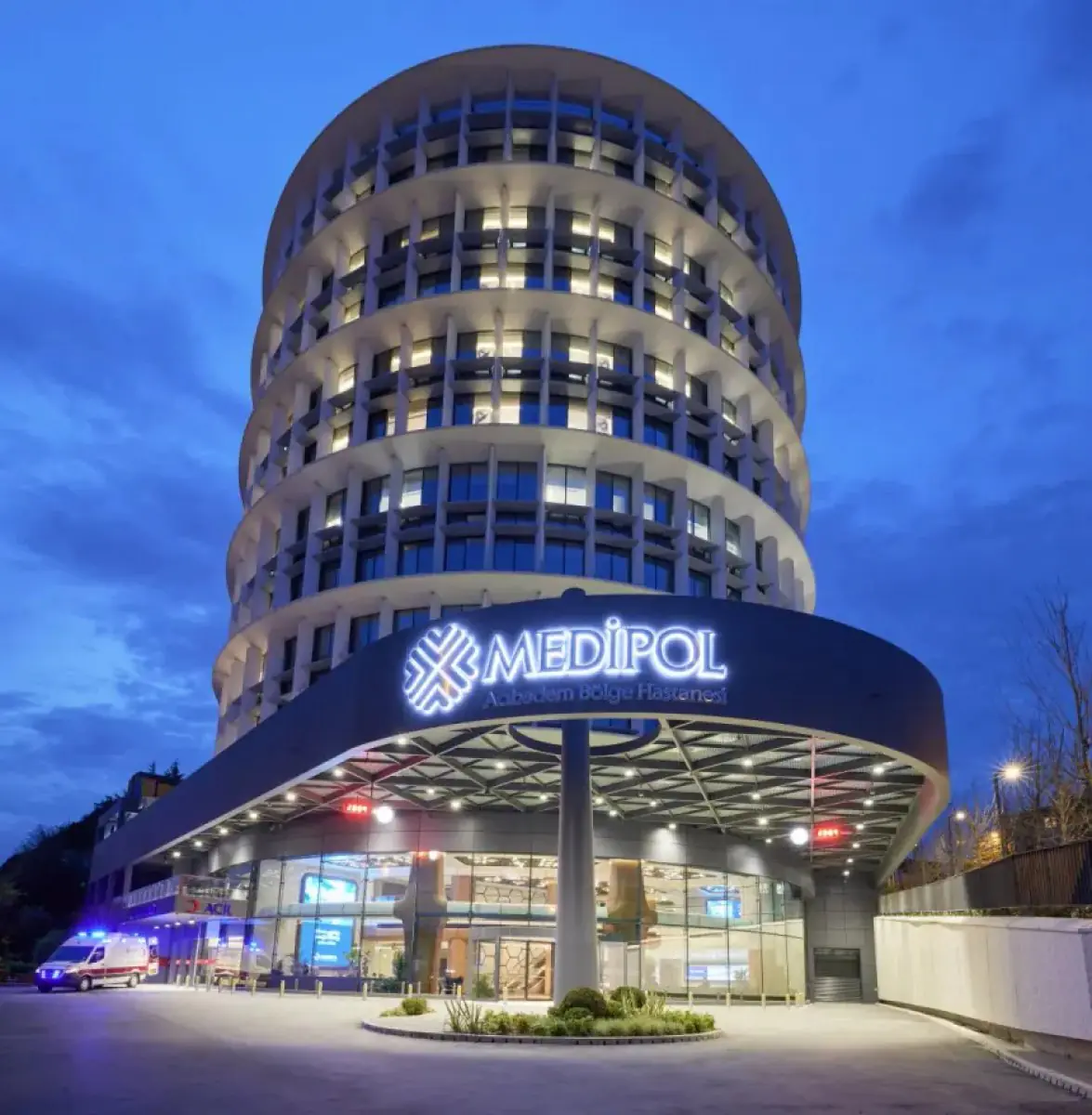Medipol Acıbadem Bölge Hospital exterior in Istanbul, modern round building at night