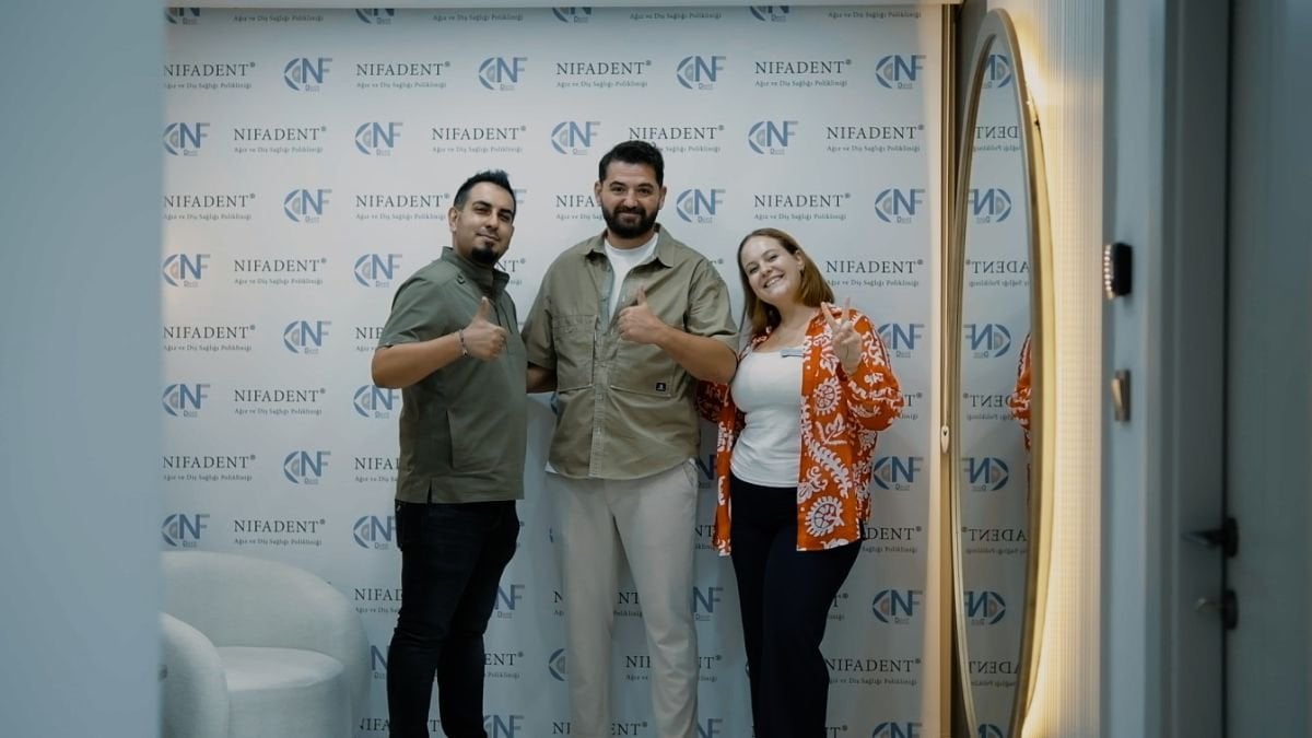 Happy patient with dental team after All-on-6 implants at Nifa Dent International clinic