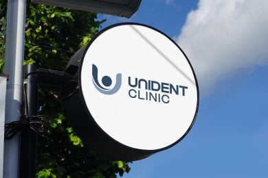 Unident Clinic outdoor sign with logo and clinic name, dental clinic branding visible