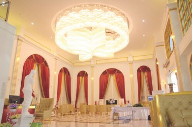 Luxurious lobby interior at Asia Cosmetic Hospital with elegant chandelier and red curtains