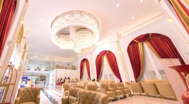 Luxurious lobby interior at Asia Cosmetic Hospital with elegant chandelier and red curtains