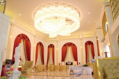 Luxurious lobby interior at Asia Cosmetic Hospital with elegant chandelier and red curtains