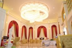 Luxurious lobby interior at Asia Cosmetic Hospital with elegant chandelier and red curtains